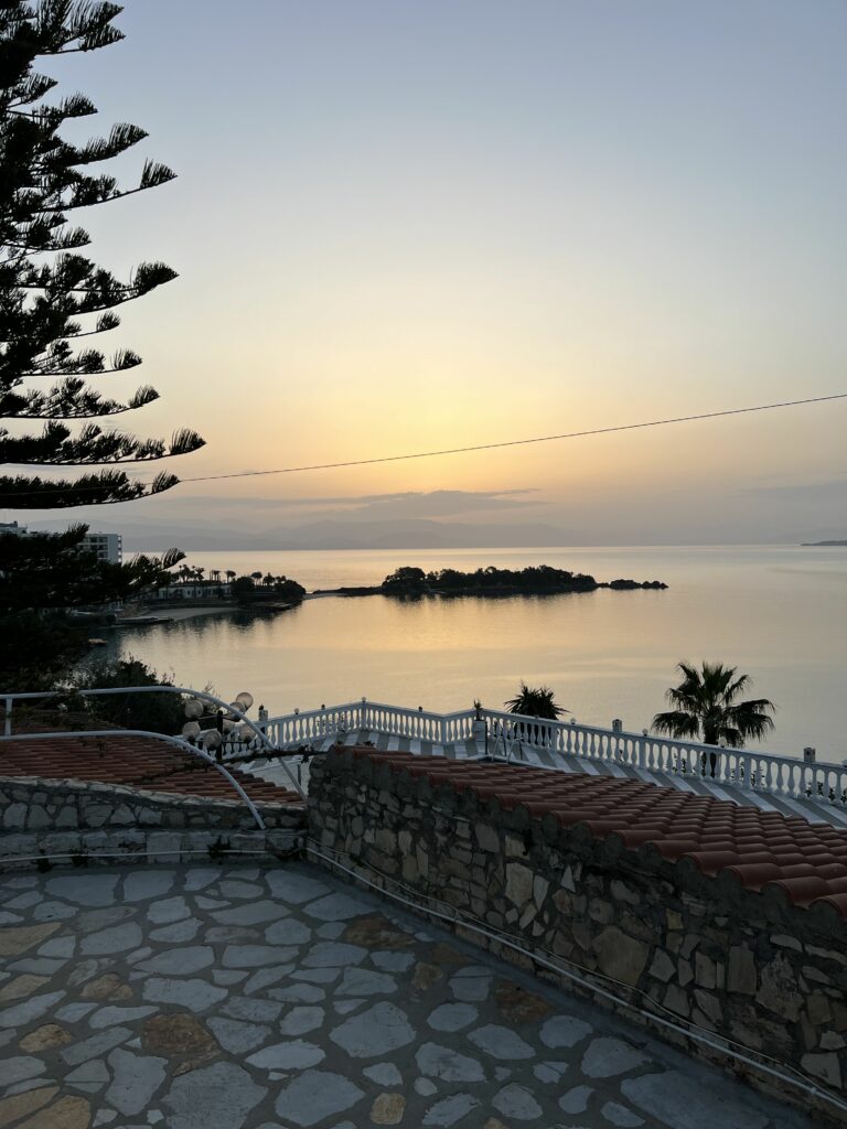 Sunrise behind the clouds seen from a backyard of a seaside house